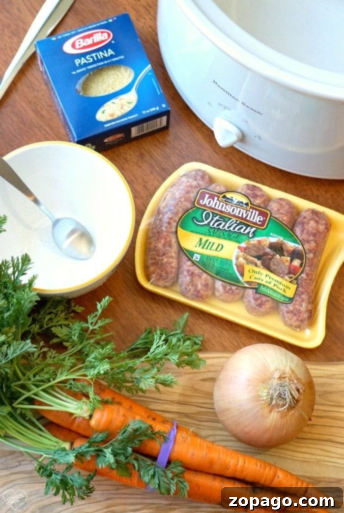 Easy Crockpot Italian Wedding Soup 4 A close-up shot of homemade Italian wedding soup with small, perfectly browned meatballs, leafy greens, and tiny pasta, showcasing its hearty and inviting texture.