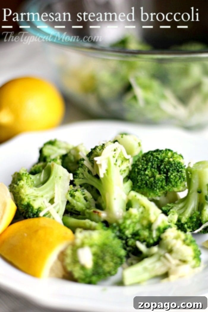Easy Steamed broccoli recipe that is packed with flavor while still being a healthy side dish to serve with just about any meal! Topped with a bit of parmesan it's the best way we've found to cook broccoli to perfection. #broccoli #steamed #healthy #sidedish #vegetable #easy Perfectly steamed broccoli served in a pristine white bowl, beautifully garnished with a generous sprinkle of Parmesan cheese and a fresh lemon wedge, ready to be savored.