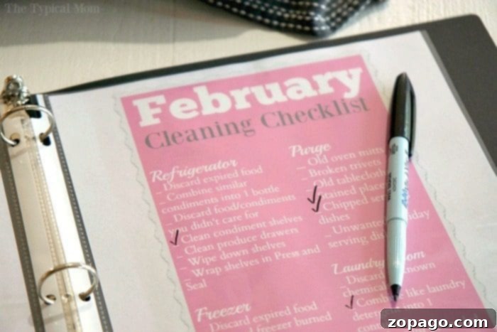 Home organization binder is genius and so easy to do! All the organization printables are here to download for free too! #organization #organize #homeorganization #printables #printable #cleaning A home organization binder lies open to a page titled February Cleaning Checklist, a black pen resting on top. Tasks under categories like Refrigerator and Freezer are itemized with checkmarks, showcasing a well-structured plan for household cleanliness and efficiency.