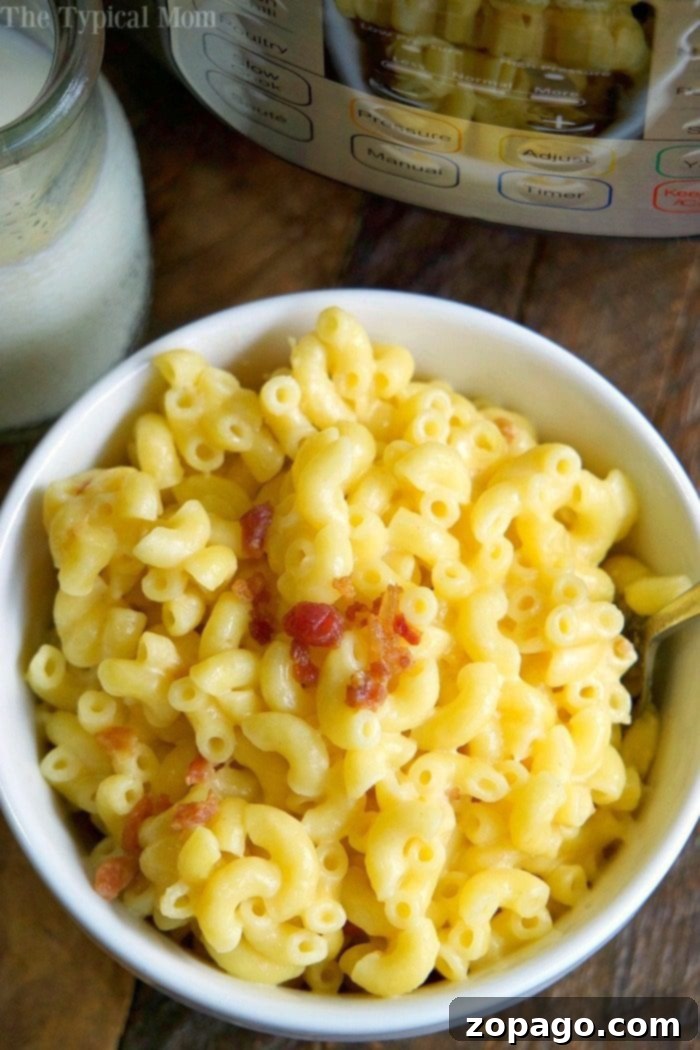 Instant Pot macaroni and cheese recipe: 8 minutes to perfect pressure cooker mac and cheese with creamy cheeses and optional bacon. Great after school snack or quick homemade meal. #instantpot #pressurecooker #macaroniandcheese #macaroni #homemade #crockpotexpress #macandcheese #instantpotrecipes #thetypicalmom creamy instant pot macaroni and cheese