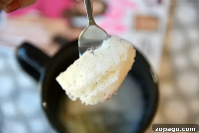Easy Angel Food Cake in a Mug recipe: a perfect, single-serving dessert that cooks in just 1 minute for a truly guilt-free treat! A close-up of a light and airy angel food cake in a mug, ready to be enjoyed as a quick dessert.