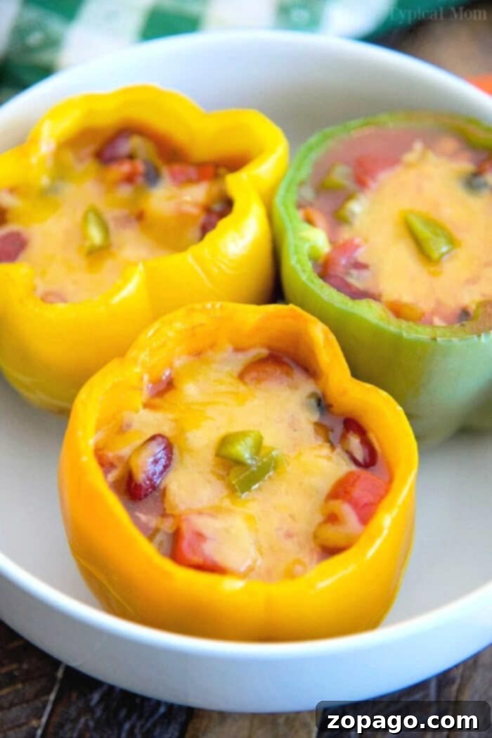 Hearty Leftover Chili Stuffed Bell Peppers 4 A vibrant platter of leftover chili stuffed bell peppers, garnished and ready for serving a healthy family dinner.