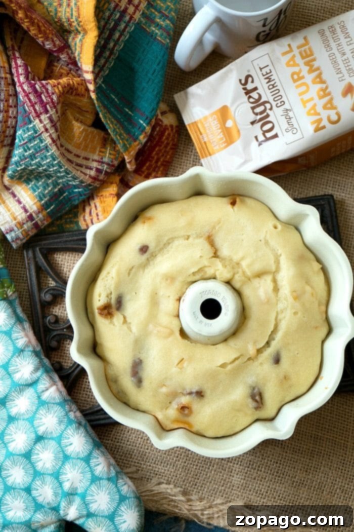 Instant Pot coffee cake is amazing! Bake it in the oven or in your pressure cooker with some coffee for the perfect breakfast. Caramel coffee cake comes out moist with all of the flavors locked in and I love it so I can bake during the summertime and not heat my house up! #coffeecake #instanntpot #pressurecooker #breakfast #instantpotrecipes #thetypicalmom #caramel #cake Caramel Apple Pecan Instant Pot Coffee Cake, ready to be shared