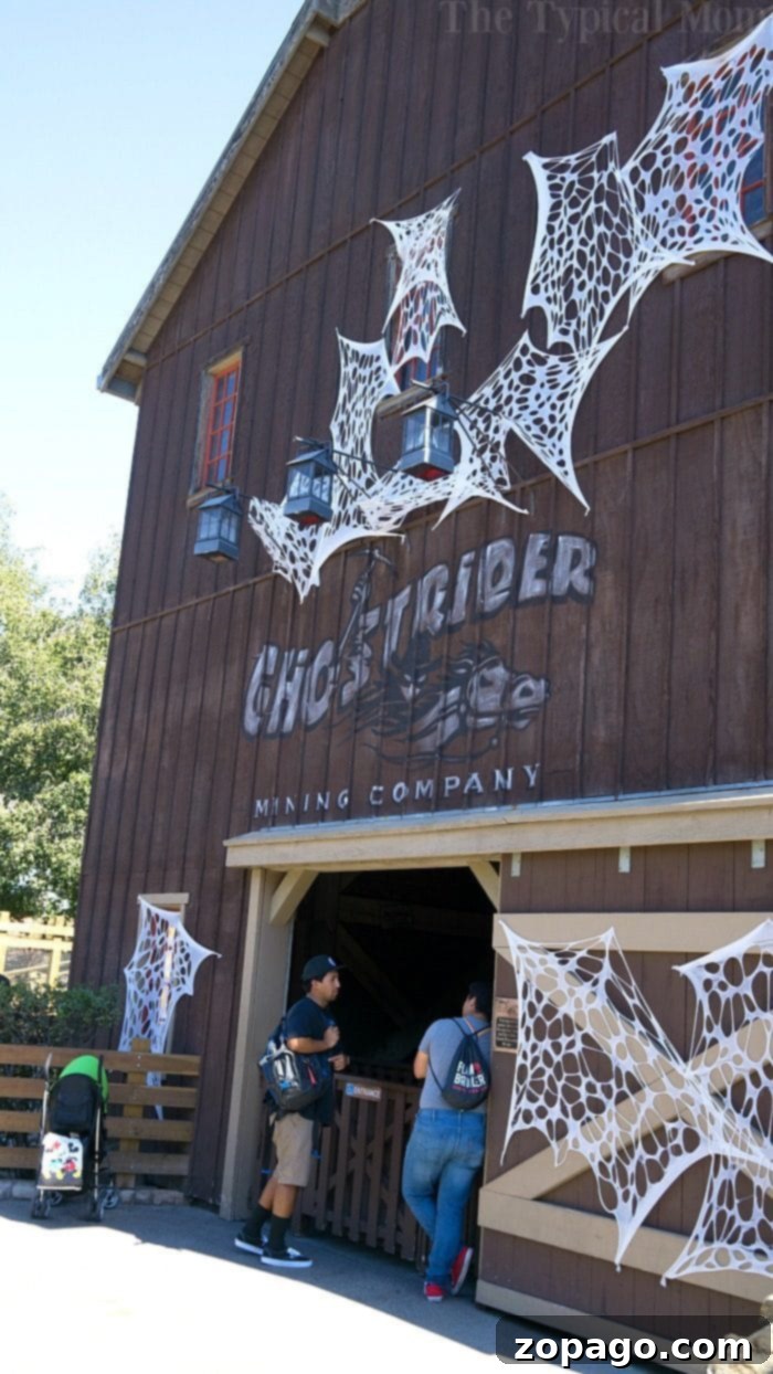 Knott's Berry Farm Spooky Farm is a great time to visit this Southern California theme park. Halloween trick or treating throughout the park make it fun! Families posing with costumed characters at Knott's Berry Farm Spooky Farm