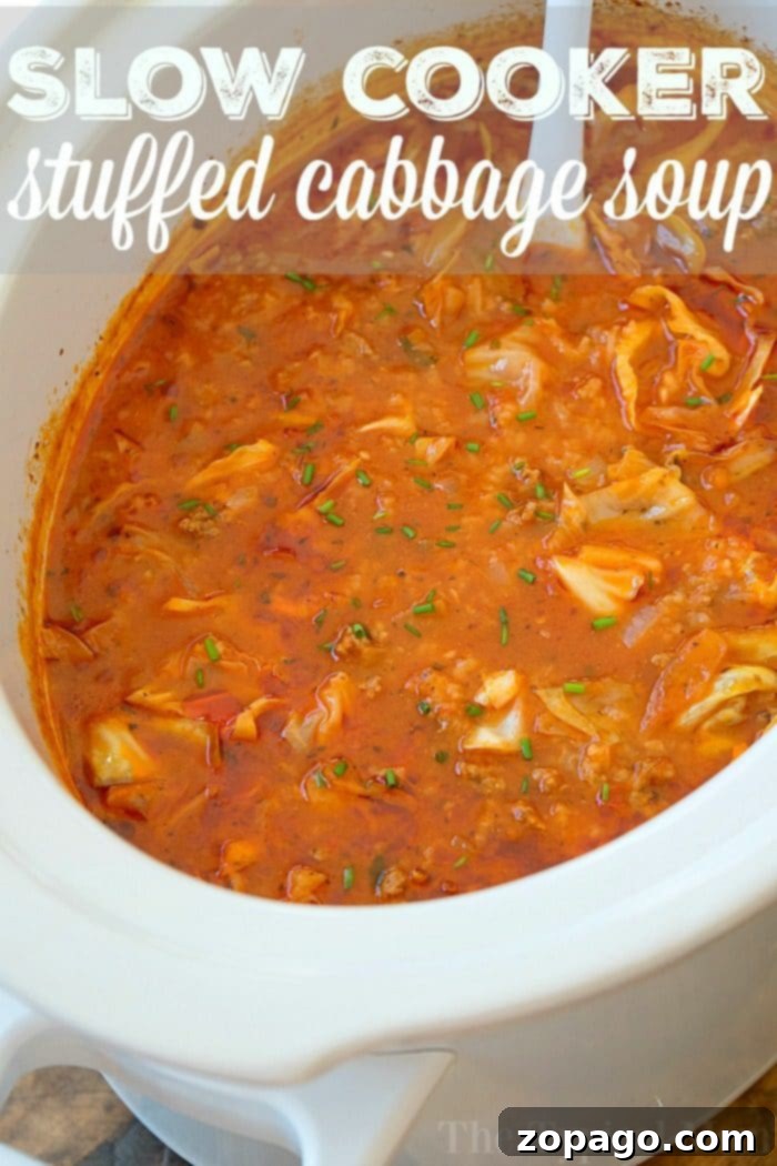 Hearty Slow Cooker Stuffed Cabbage Soup for Dinner A large pot of slow cooker stuffed cabbage soup, ready to serve, filled with tender cabbage, ground sausage, and a rich tomato broth. Ideal for a cozy family dinner.