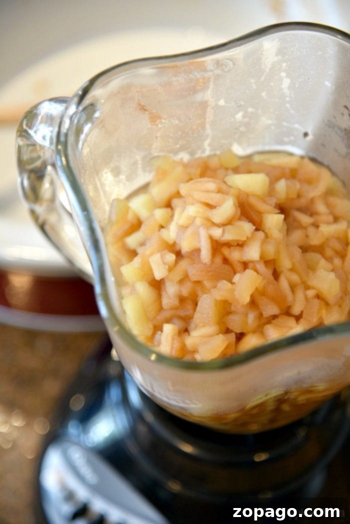Instant Pot applesauce: clear, step-by-step instructions for a perfect batch every time, highlighting the tender cooked apples. Detailed visual instructions for making Instant Pot applesauce, showcasing a close-up of perfectly cooked and tender apple slices in the pot, ready for mashing.