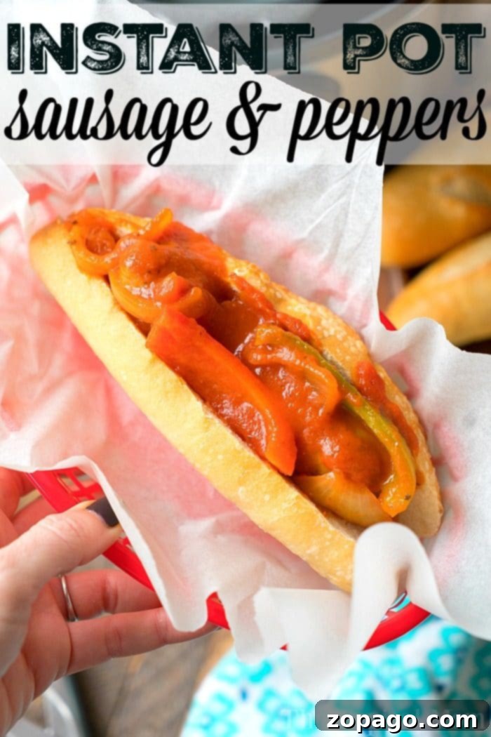 Easy Instant Pot Sausage and Peppers 3 A hand holds a red basket lined with white paper, containing a sub sandwich filled with sausages and red and green bell peppers in a tomato-based sauce. Text at the top of the image reads, "Pressure Cooker Sausage & Peppers.