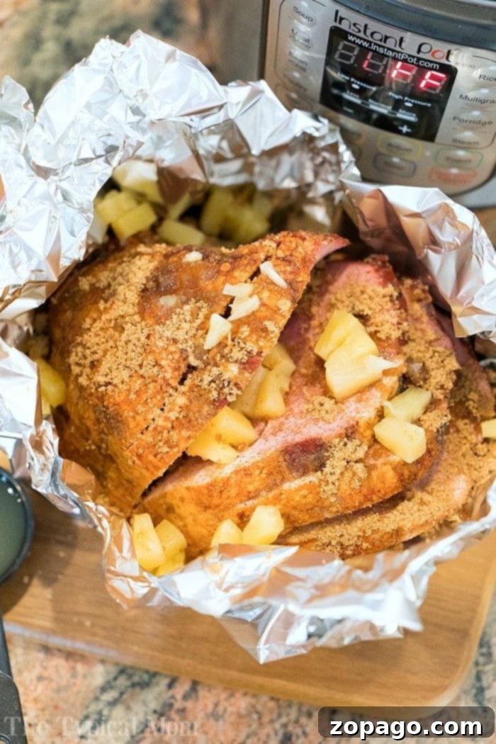 Instant Pot ham done in just 20 minutes! If you want an easy honey ham recipe you've gotta' try it in your pressure cooker. #instantpot #ham #honey #pressurecooker #instantpotrecipes #thetypicalmom #ninjafoodi #glaze easy honey ham