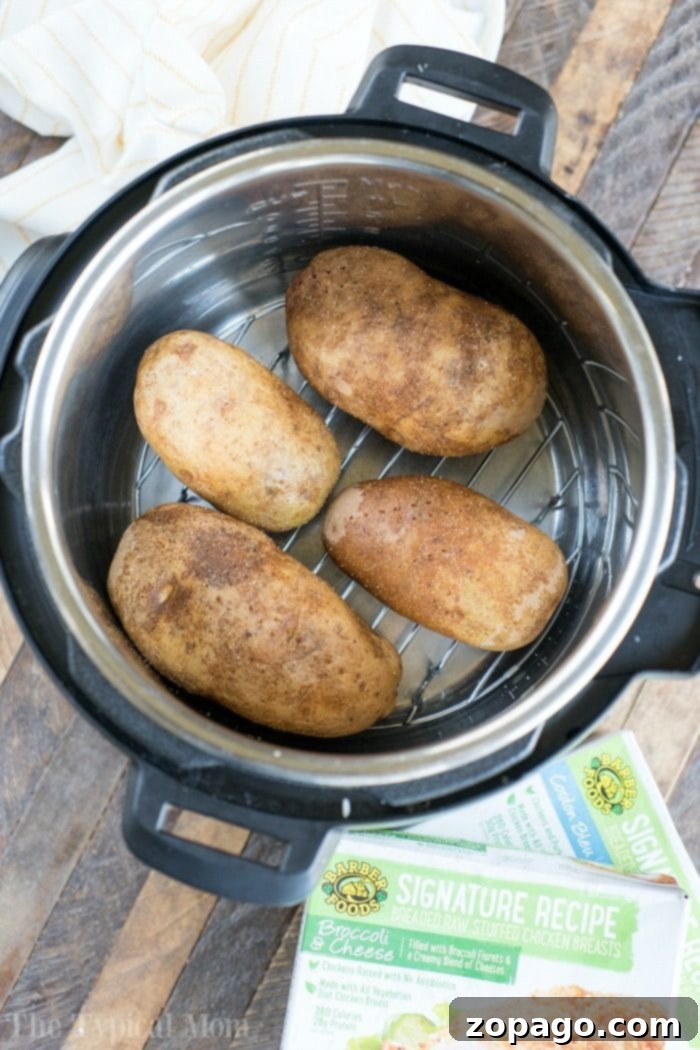 Pressure cooker baked potatoes and stuffed chicken are a great duo! Instant Pot dinner success again. #pressurecooker #instantpot #bakedpotatoes #potatoes #sidedish #instantpotrecipes #thetypicalmom #ninjafoodi Pressure cooker baked potatoes and stuffed chicken - a perfect dinner duo