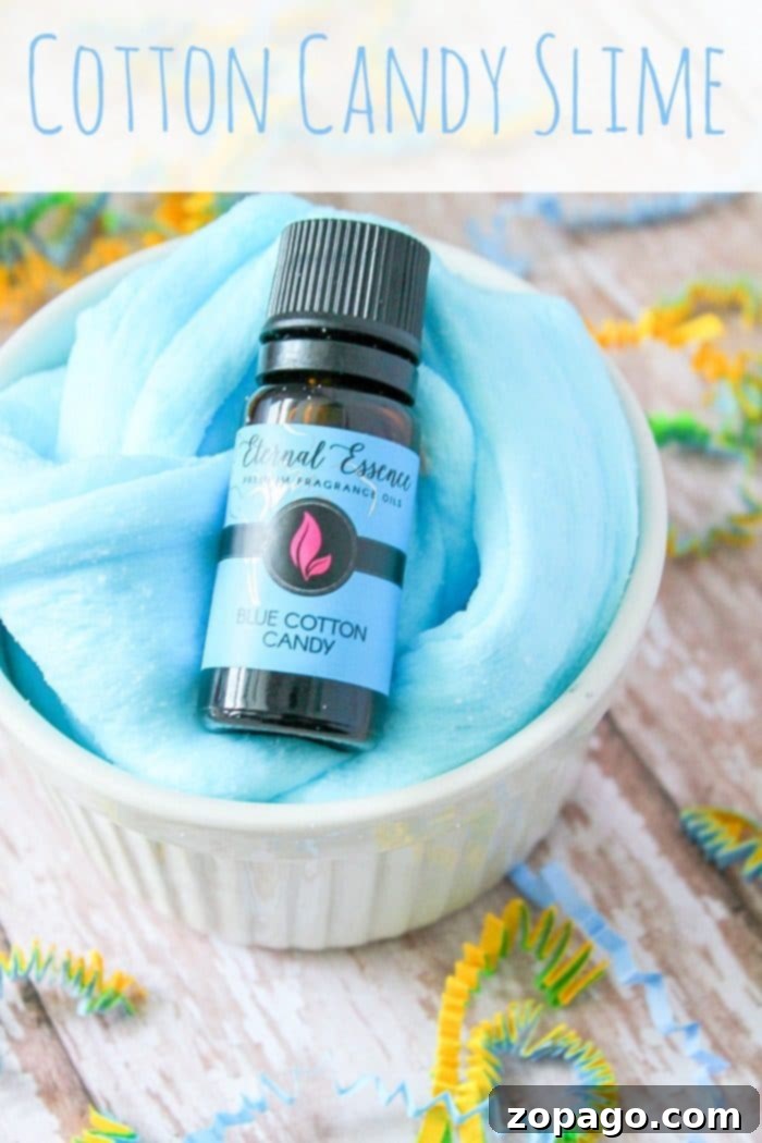 Adding Fragrance to Your Homemade Slime A small bottle of blue cotton candy scent oil, used to infuse slime with fragrance, resting beside other slime-making components.