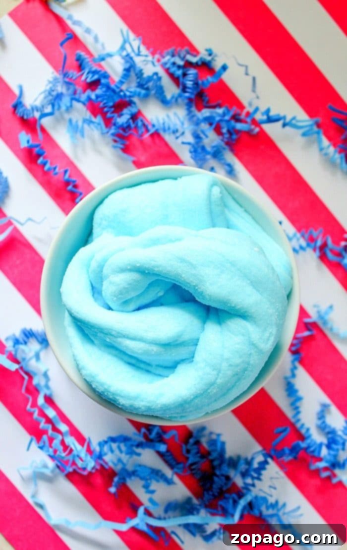 Gather Your Materials for Homemade Scented Slime Various slime ingredients laid out on a clean surface, including bottles of glue, liquid starch, a container of instant snow, and a small bottle of blue dye.