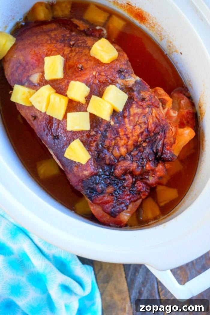 This pineapple crockpot ham recipe is sweet, tender, and delicious. Cooks on it's own in your slow cooker and is ready when you are, perfect for holidays! #crockpot #slowcooker #ham #pineapple #christmas #dinner #easter Crockpot Ham Recipe