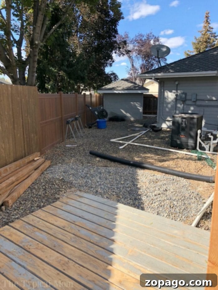 Selecting and preparing the ideal spot for a DIY fire pit in a backyard setting. DIY backyard fire pit construction showing the selected location and prepared ground.