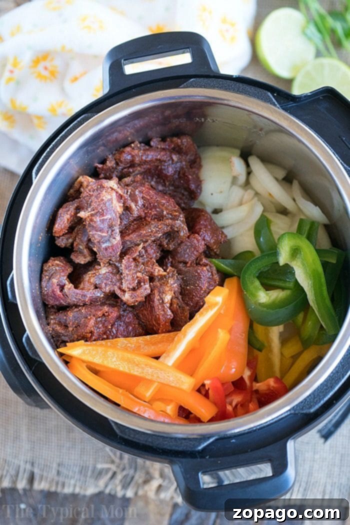 Instant Pot fajitas are great and take just minutes to cook to tender perfection. Flavorful marinated beef and vegetables are for dinner tonight! #instantpotrecipes #thetypicalmom #instantpot #fajitas #beef #lowcarb #ninjafoodirecipes #crockpotexpress Instant Pot Fajitas served with fresh toppings