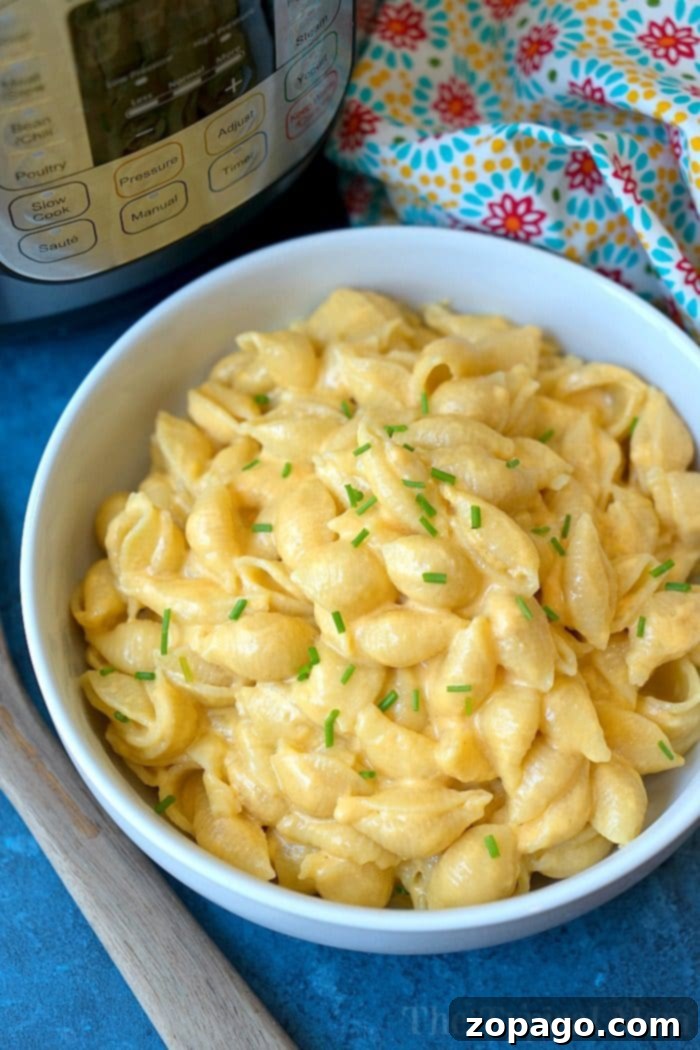 Year's Best Instant Pot Dishes 4 Creamy Instant Pot macaroni and cheese in a large serving bowl, garnished with fresh parsley.