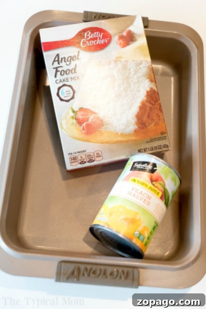Effortless Peach Angel Food Dump Cake - A quick and easy, fat-free cake recipe ideal for any peach lover. A beautifully baked peach angel food cake, golden brown on top, in a 9x13 inch baking pan. The edges are perfectly risen, and the cake appears incredibly light and inviting.