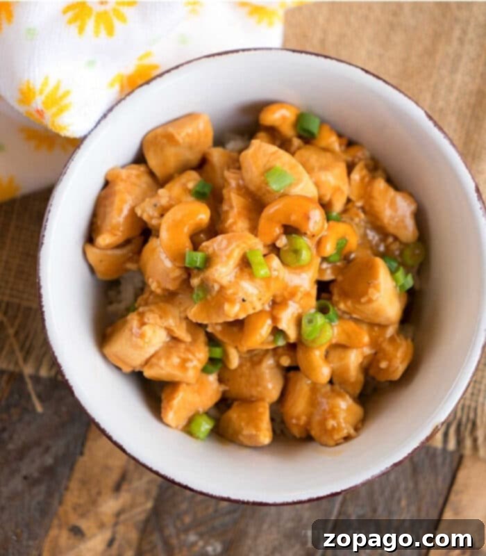 Easy Instant Pot Cashew Chicken 2 A vibrant bowl of Pressure Cooker Cashew Chicken, garnished with fresh green onions, promises a quick and delicious meal.