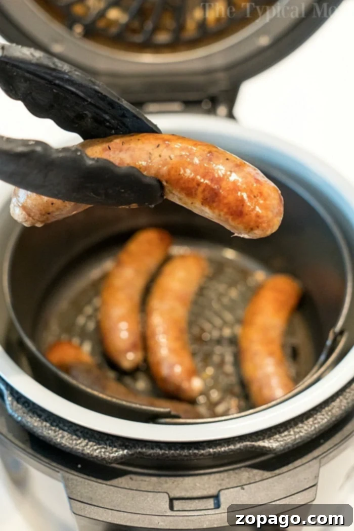 Ninja Foodi brats is a great dinner! Using fresh or frozen brats or sausage links you can make them tender on the inside with that snap on the outside! #ninjafoodi #ninjafoodirecipes #pressurecooker #airfryer #sausage #brats #bratwurst Ninja Foodi frozen sausage ready to be cooked