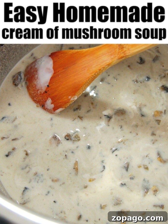 Homemade cream of mushroom soup recipe you can use to make green bean casserole or add to anything else. Made from scratch is always best and tastes amazing. #homemade #creamofmushroom #soup #mushroom A close-up reveals the rich texture of homemade cream of mushroom soup being gently stirred with a wooden spoon in a pot.