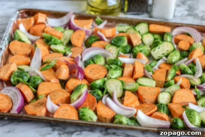 One-Pan Golden Chicken Thighs 4 sheet pan vegetables with chicken, featuring sweet potatoes and brussels sprouts
