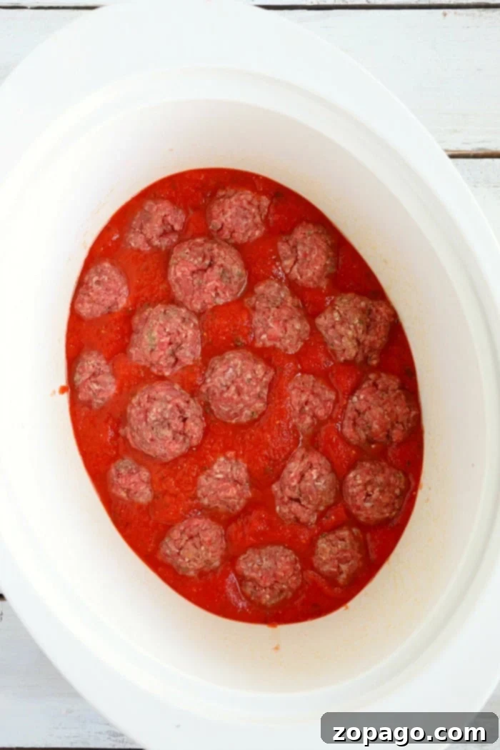 Slow cooker spaghetti is a game changer! NO need to boil noodles when making this pasta dinner in your slow cooker. Homemade comfort food. crockpot meatballs