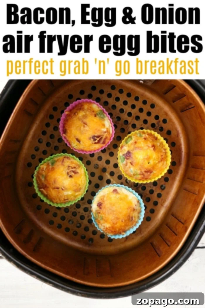Air fryer egg bites like Starbucks filled with bacon, cheese and onions are the best low carb and keto breakfast idea ever! Like Starbucks egg bites but customized! #airfryer #airfryerrecipes #ninjafoodirecipes #eggbites #starbuckseggbites #airfryereggbites Close-up of golden Ninja Foodi egg bites, highlighting their delicious texture and cooked toppings.