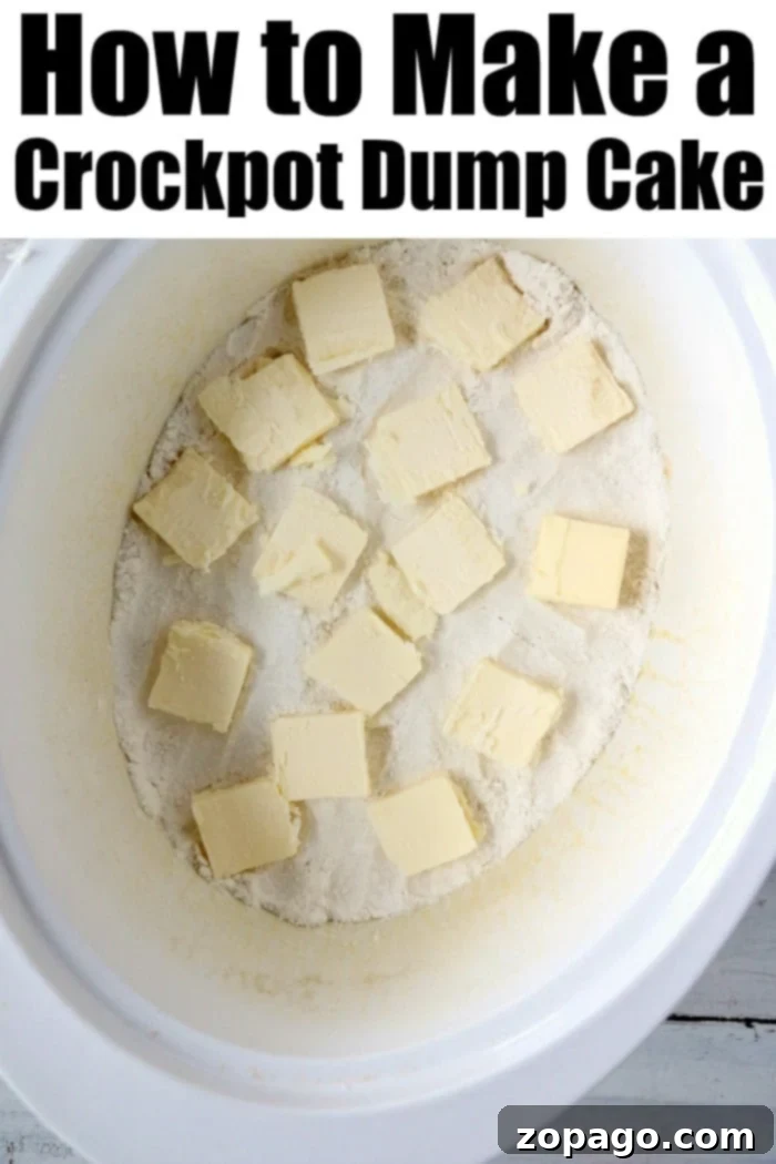 Crockpot dump cake is ooey gooey with caramel and pecans in it too. Top with vanilla ice cream and OH MY it's a great slow cooker dessert. #crockpotdessert #dumpcake #appledumpcake #crockpotcake #applecake #carameldumpcake A scoop of Slow Cooker Apple Dump Cake on a white plate with cinnamon sticks