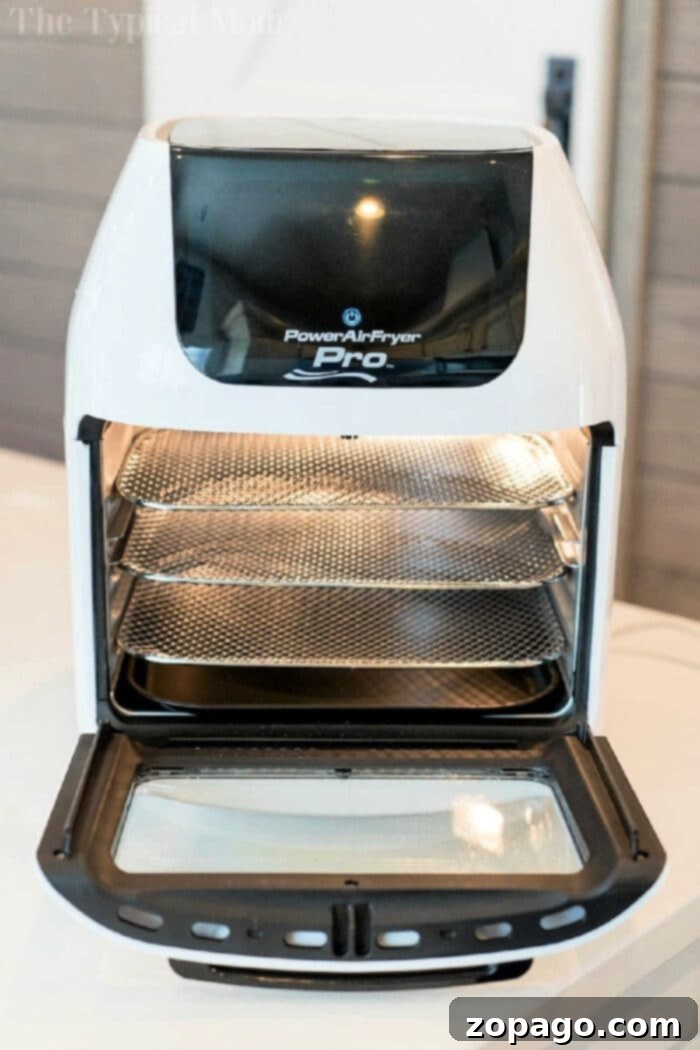 Discover the Power Air Fryer Pro: The best large air fryer on the market, featuring 3 racks for air frying and dehydrating. Ideal for family meals and versatile cooking. #BestAirFryer #LargeAirFryer #PowerAirFryerProReview #AirFryerOven #Dehydrator The Power Air Fryer Pro, a top-rated large air fryer oven, showcased in a kitchen setting. It's perfect for families needing ample cooking space and offers multiple racks for versatile meal preparation and dehydrating. A truly efficient kitchen appliance.