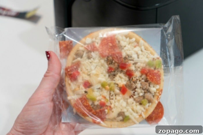 Perfect Air Fryer Frozen Pizza Every Time 4 Perfectly cooked small frozen pizza with melted cheese and crispy crust, fresh out of the air fryer.