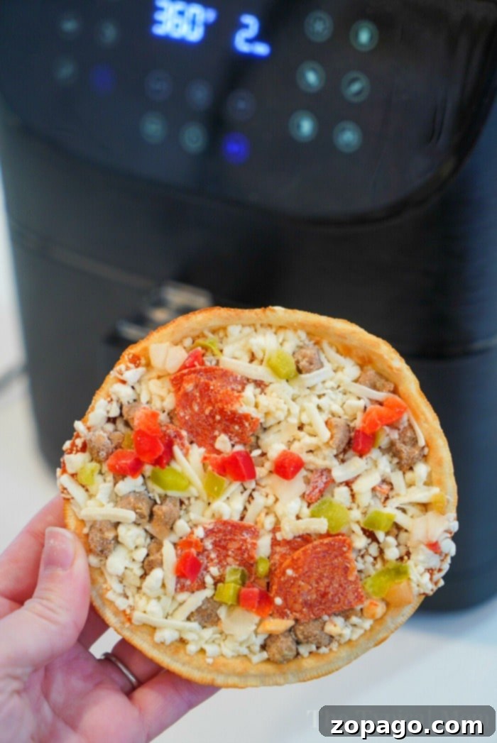 Perfect Air Fryer Frozen Pizza Every Time 5 Delicious frozen pizza expertly cooked in an air fryer or Ninja Foodi, showcasing a crispy crust with melted cheese and pepperoni toppings. This is a favorite method for quick and tasty meals.