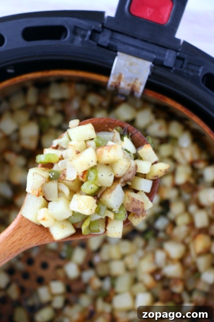 Air fryer breakfast potatoes with bell peppers topped with cheese are great with eggs, or make breakfast for dinner some night! Cheap and full of flavor. diced potatoes