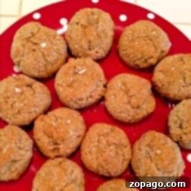 Classic German Lebkuchen 4 Lebkuchen cookies on a red polka-dot plate, drizzled with honey.