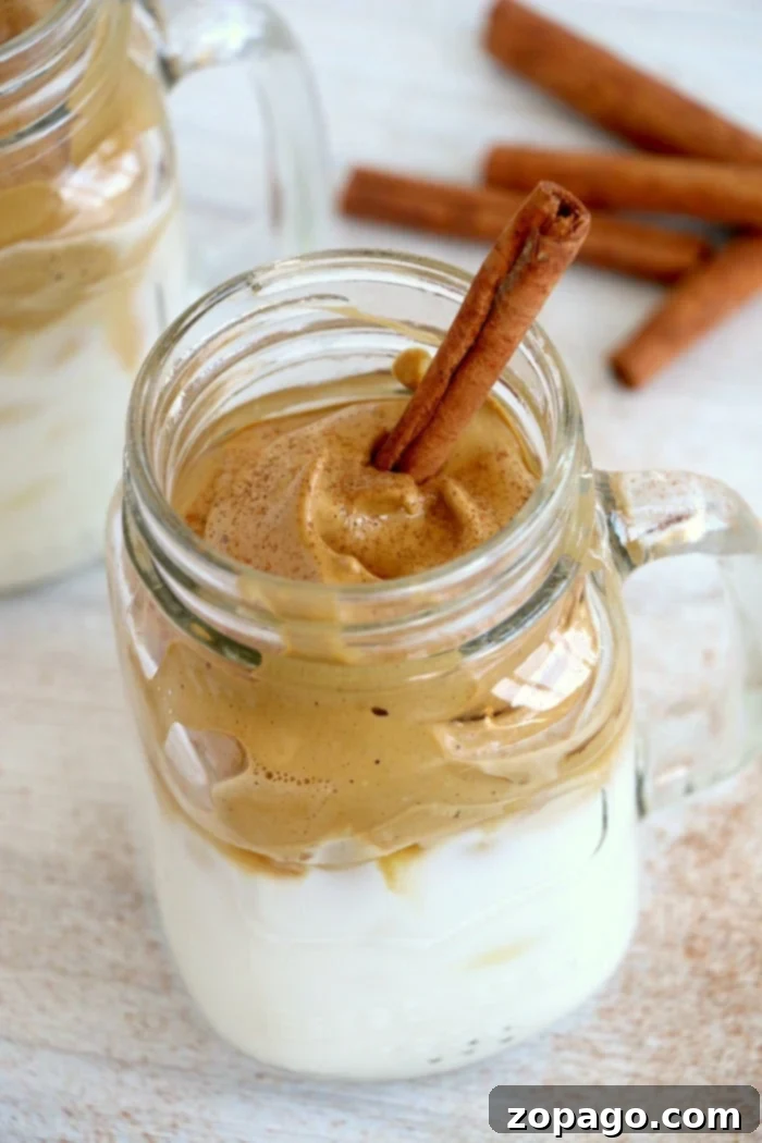 Trendy Dalgona whipped coffee recipe! EASY to make this popular TikTok drink everyone is going crazy over. I bet you'll love it too. The finished Dalgona whipped coffee drink, showcasing its distinct layers and irresistible foam, ready to be enjoyed.