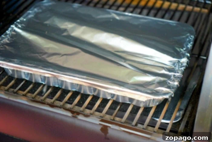 Smoky Garden Delights 5 fresh-vegetables-on-the-smoker-in-a-foil-pan