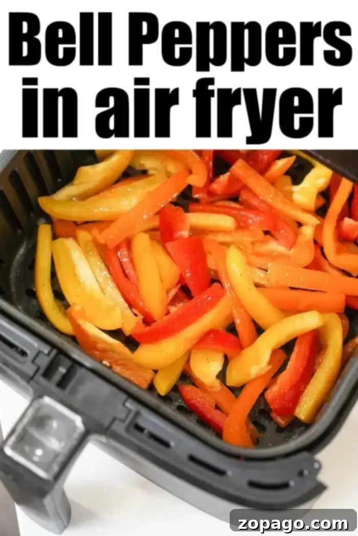 Air-Fried Bell Peppers: Quick, Easy, and Flavorful 6 Sliced red, yellow, and orange air fryer peppers are delicately arranged inside the basket, perfectly cooked. The text "Bell Peppers in Air Fryer" adorns the top.