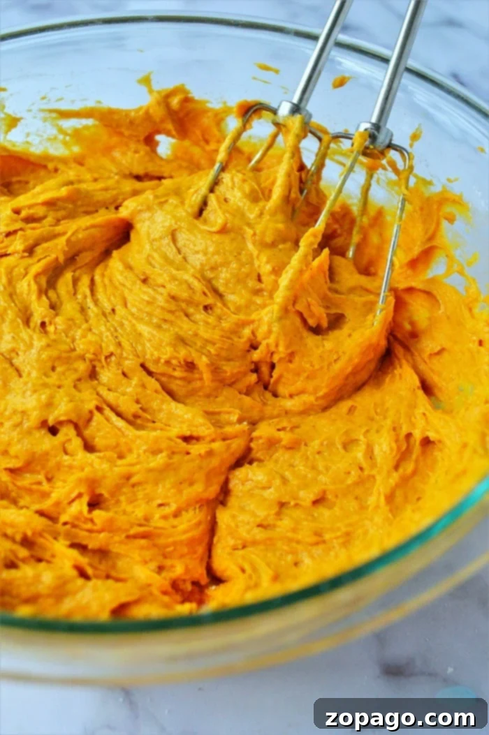 Easy Pumpkin Cake Mix Cookies 5 A stack of freshly baked pumpkin cookies, highlighting their soft texture and golden-brown edges.