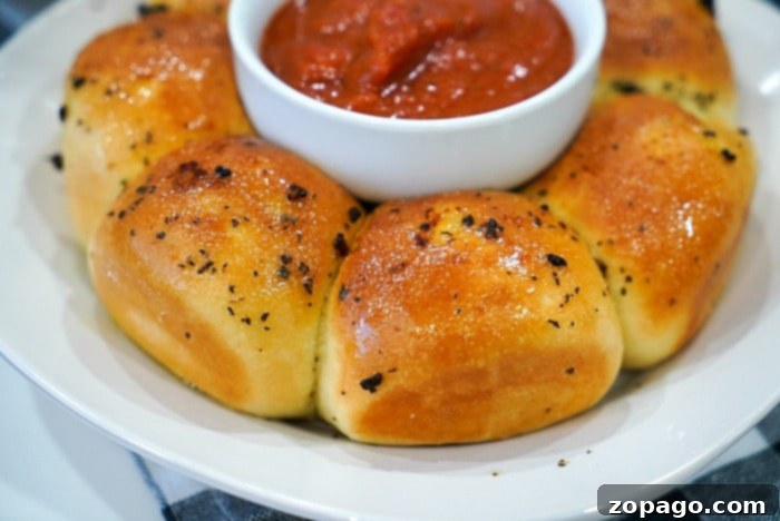 Crispy Air Fryer Frozen Rolls 10 Close-up of golden pull-apart garlic bread, generously coated in herbs.