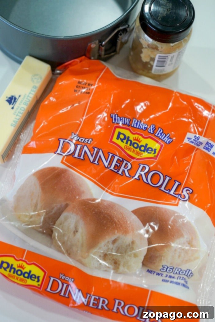 Crispy Air Fryer Frozen Rolls 3 Frozen Rhodes dinner rolls arranged in a baking pan, ready for thawing and rising.