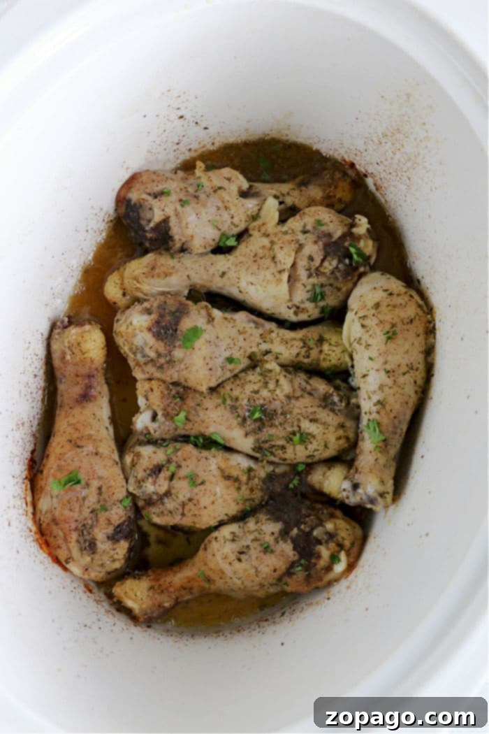 Fall-Off-The-Bone Slow Cooker Chicken Legs 6 Tender crockpot chicken recipe, showing seasoned drumsticks ready to cook.