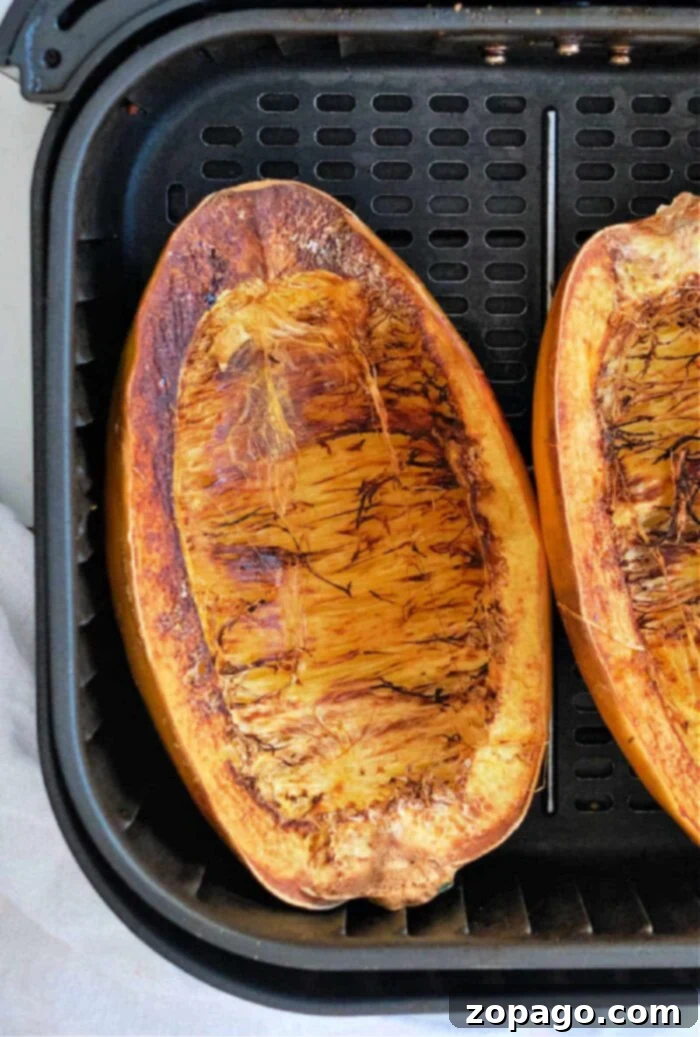 Easy Air Fryer Spaghetti Squash 8 Another appealing view of air-fried spaghetti squash halves, showcasing their tender texture and golden edges before being turned into 'pasta'.