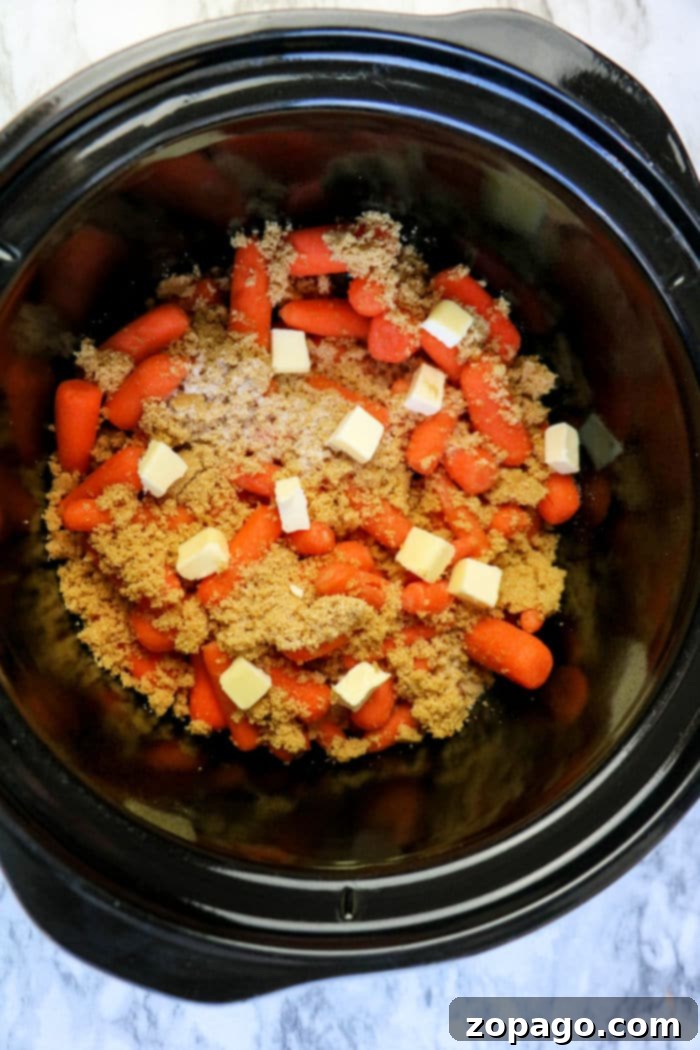 Glazed Slow Cooker Carrots 4 Close-up of crockpot glazed carrots with a rich, glossy brown sugar and butter coating.