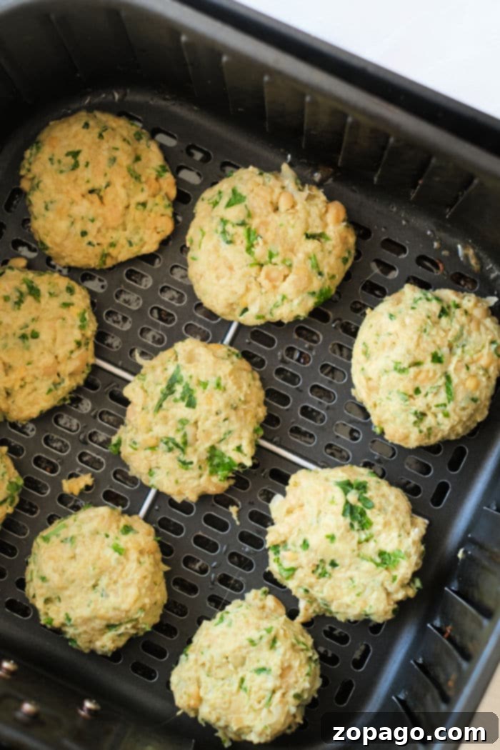 Crispy Air Fryer Falafel 10 Falafel cooking in an air fryer basket