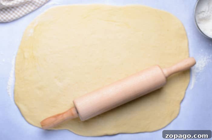 The Art of Braided Bread 5 Rolling out sweet bread dough for a cinnamon wreath.