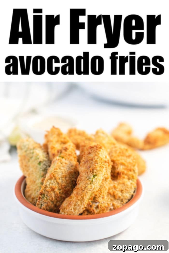 A small white bowl brimming with golden-brown air fryer avocado fries sits invitingly on a light surface.