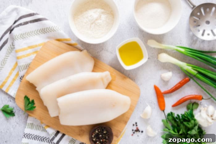 Mastering Crispy Calamari at Home 3 Fresh calamari rings, perfectly prepared and ready for cooking, showcasing their distinct shape and promising a tender and delicious seafood dish.