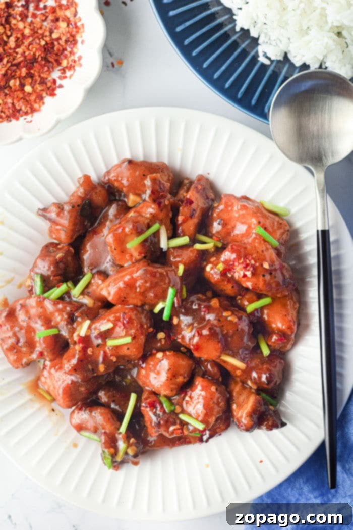 Golden Crisp Air Fryer Sesame Chicken 7 Air Fryer honey garlic Chicken, coated in sauce and ready to be served.