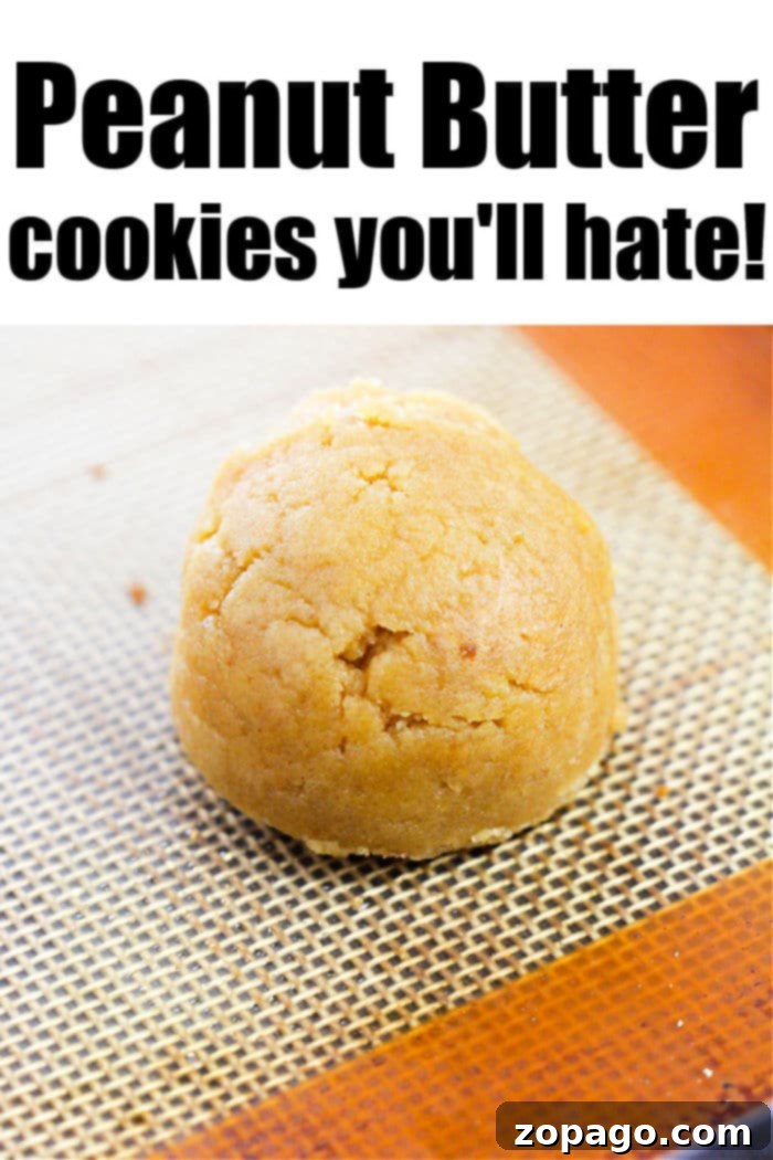 Effortless Four Ingredient Peanut Butter Cookies 3 A single perfectly baked peanut butter cookie sits on a baking mat, exhibiting its classic crisscross fork marks. The text above the cookie reads