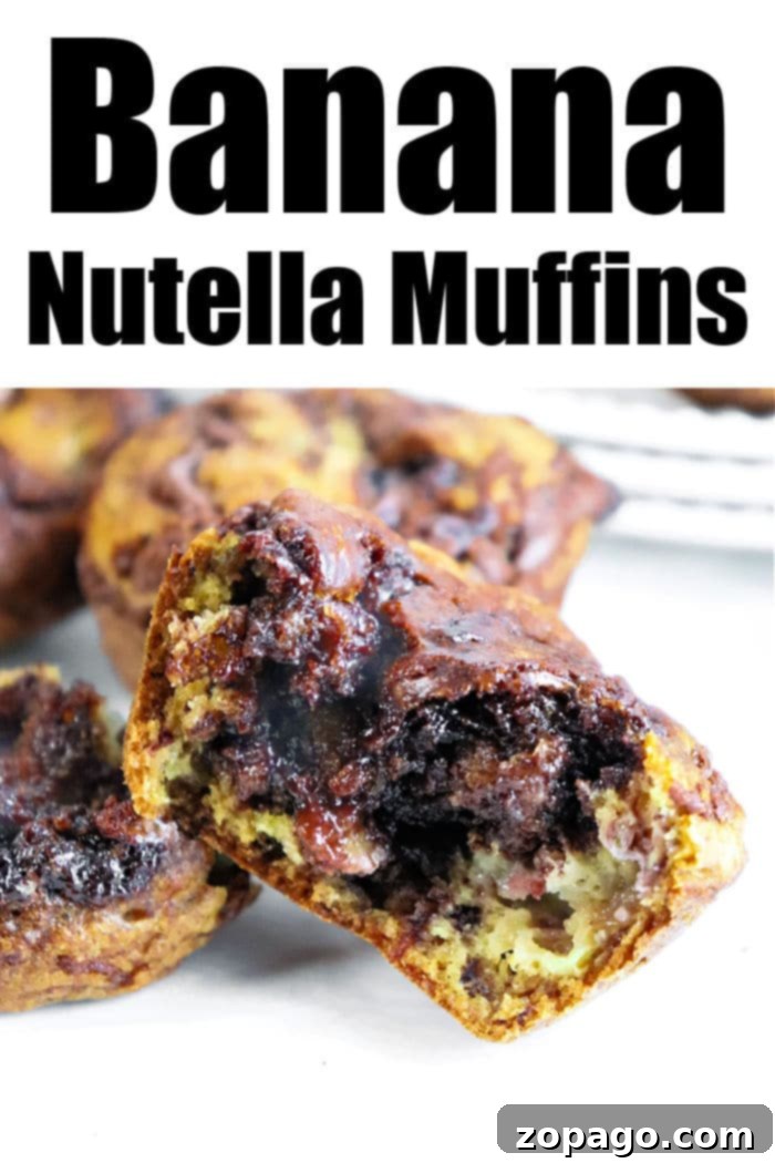 Nutella-Swirled Banana Muffins 7 A beautifully arranged selection of Banana Nutella Muffins, golden brown and swirled with chocolate, ready to be enjoyed.