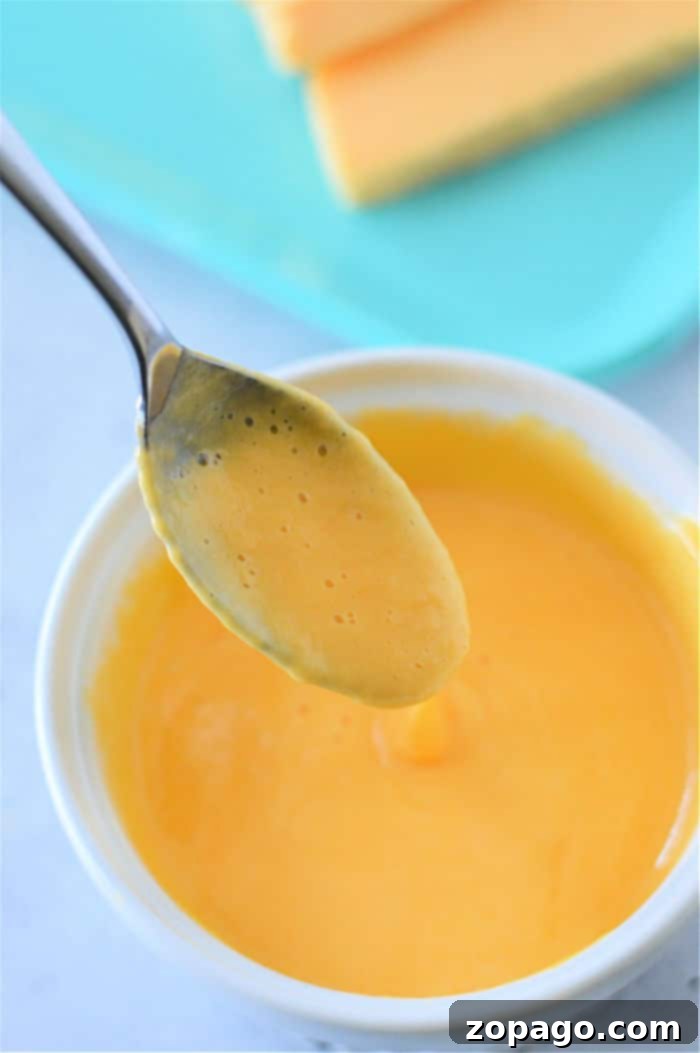 Make the Best Velveeta Cheese Sauce 10 Steamed broccoli florets generously topped with rich, creamy homemade cheese sauce, creating a delicious and appealing side dish.