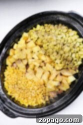 A crockpot brimming with corn, lima beans, diced potatoes, and zesty seasonings creates a delicious riff on Brunswick stew.